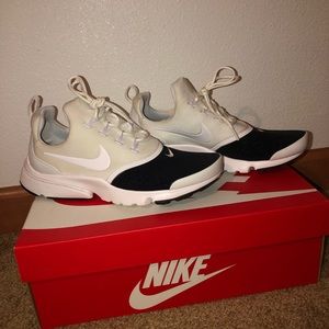 Cream, White, and Black Nike Tennis Shoes